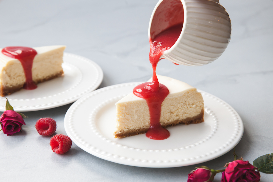 Topping cheesecake with a drizzle of coulis