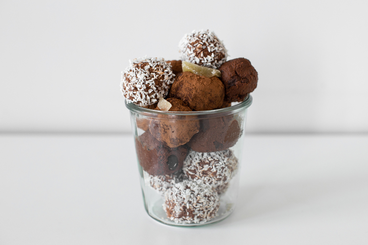 Three flavours of vegan chocolate truffles in a clear container