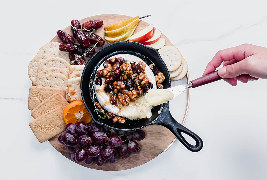 Serving of baked brie with nuts and dried fruit