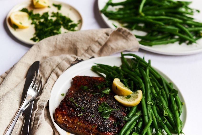 Blackened trout and green beans on plate