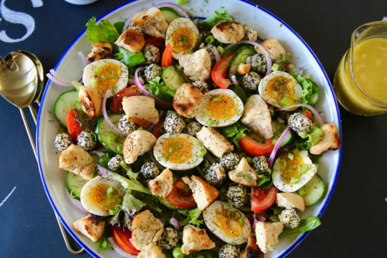 plate of salad with eggs, tomatoes, cucumbers and croutons