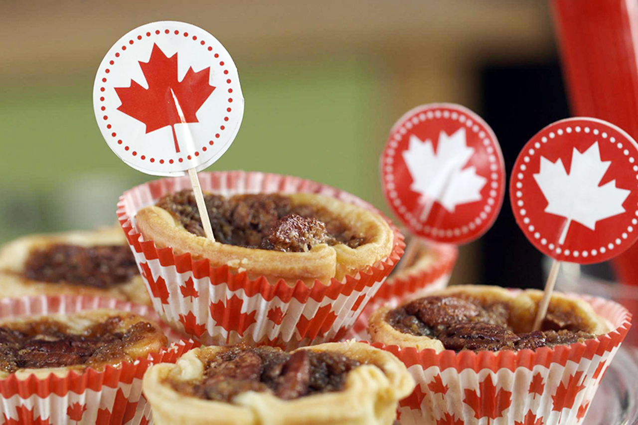 Butter tarts with red maple leaf decorations