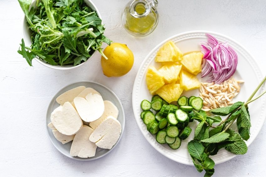 Grilled halloumi cheese salad ingredients on countertop