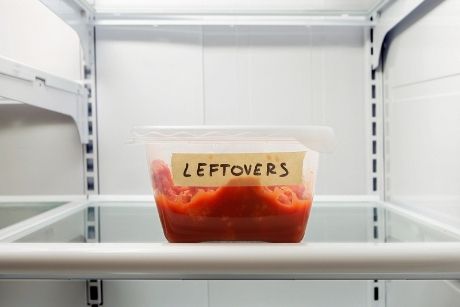 Leftovers in plastic container in fridge