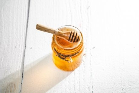 Honey in a jar on countertop