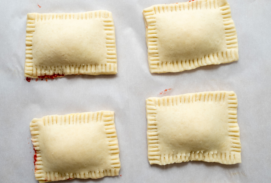 unbaked pastry pockets on parchment paper