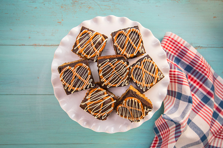 Sweet and salty peanut butter pretzel crust brownies on a plate