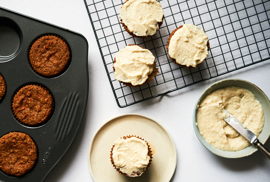 putting frosting on guilt-free paleo carrot cupcakes