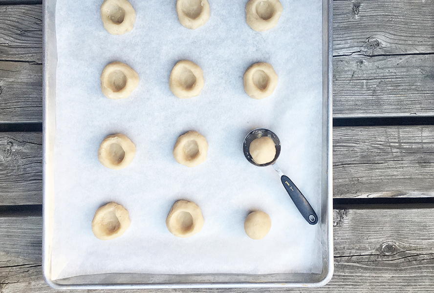 baking sheet with pie thumbprint cookie dough before filling is added