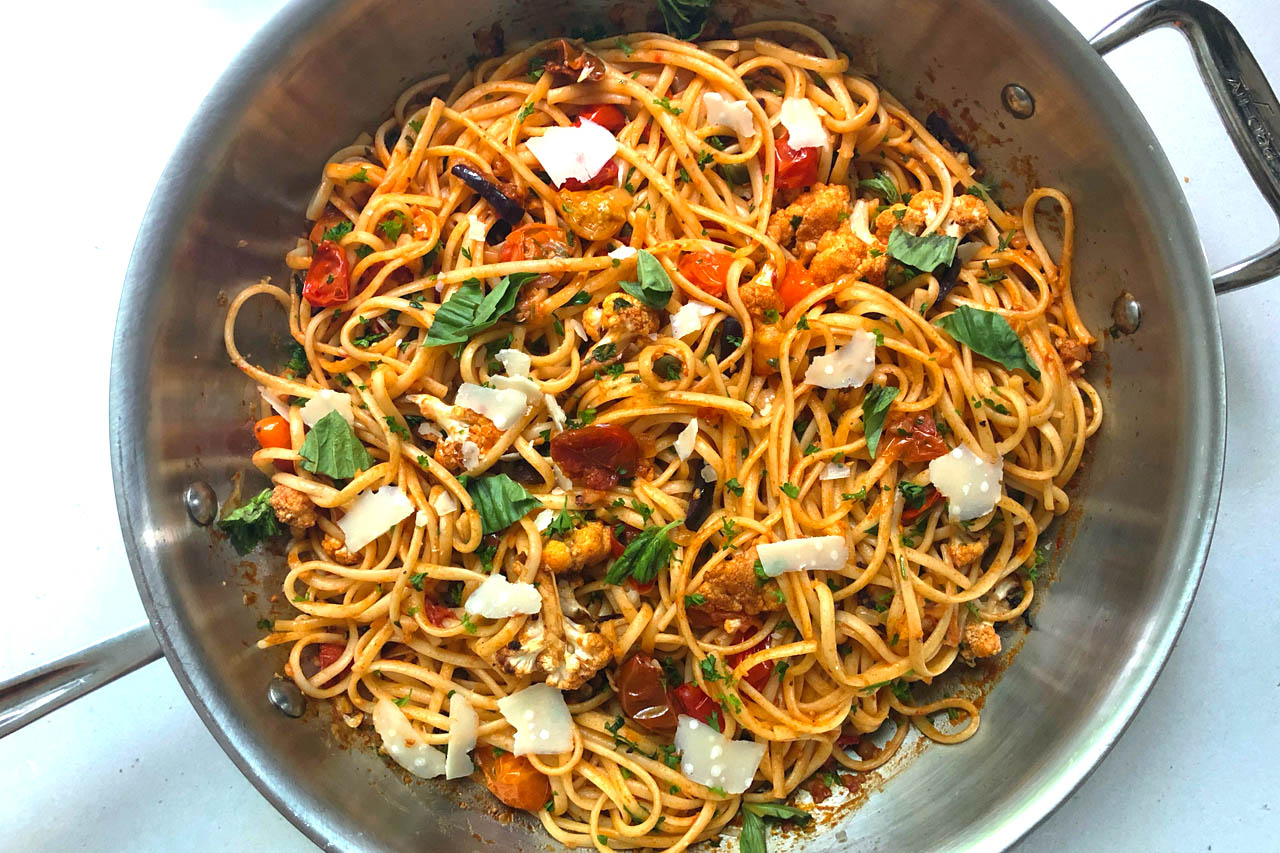 spaghetti puttanesca with cauliflower in a metal pan