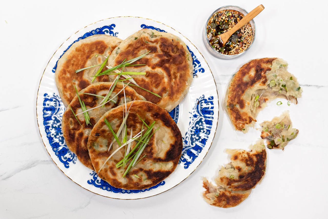 scallion pancakes on a white and blue plate