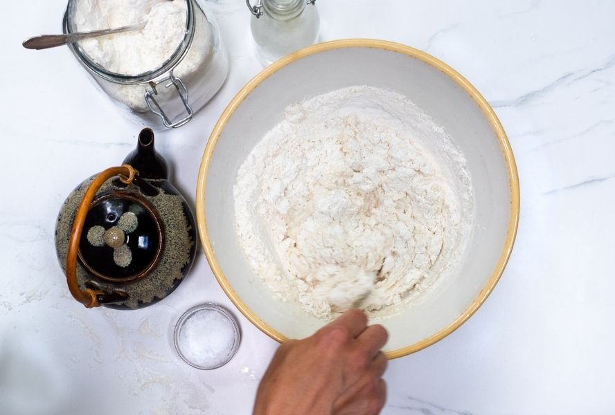 Person mixing scallion pancakes dough