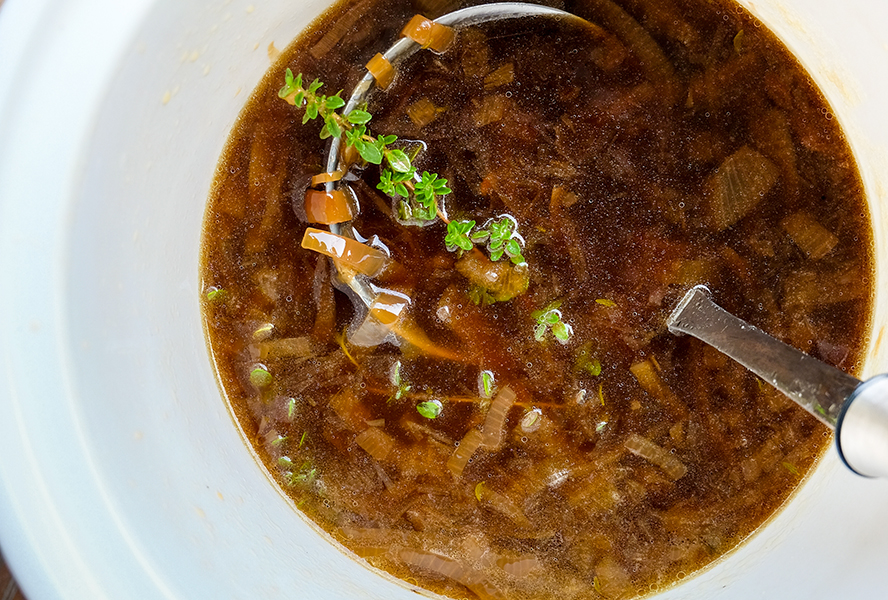 slow cooker french onion soup in a while bowl