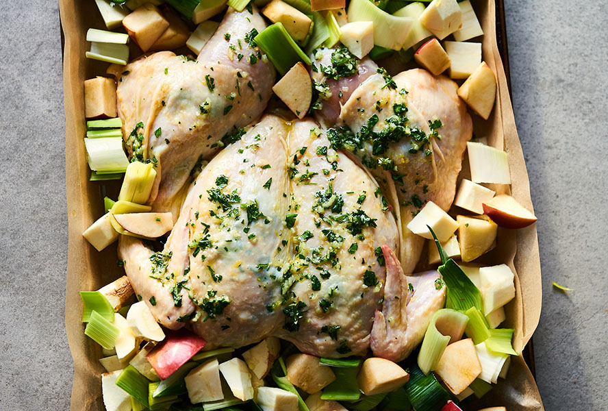 Lemon spatchcock chicken with veggies on roasting pan