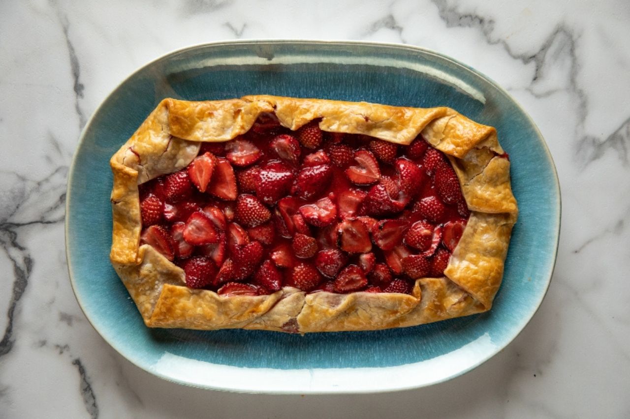 rustic strawberry tart on a green plate