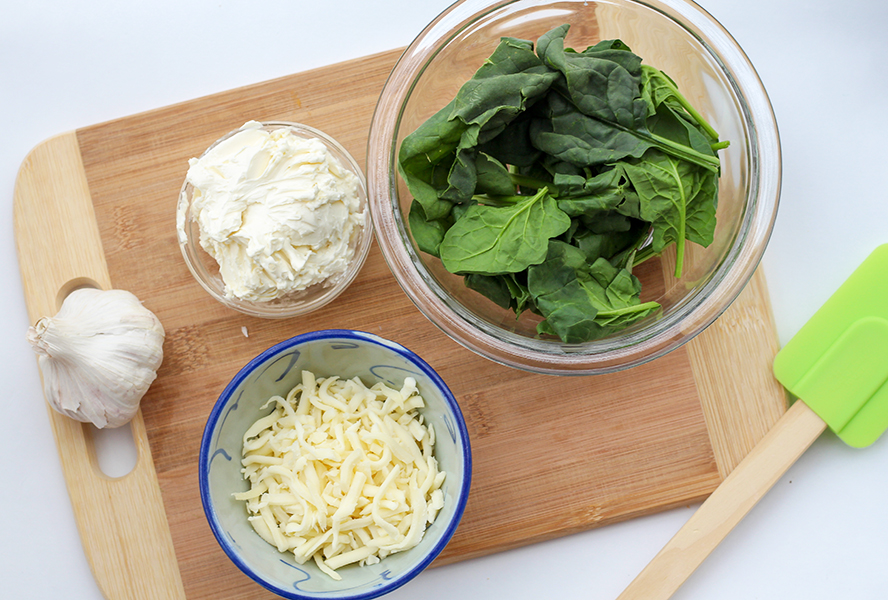 Ingredients for cheesy stuffed chicken breast including spinach, garlic and cheese