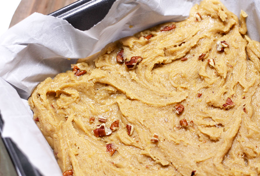 The batter for sweet potato blondies in a parchment-lined tray