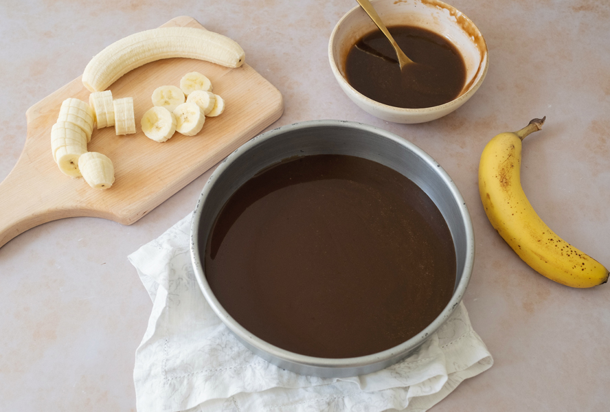 overhead of toffee sauce with sliced bananas