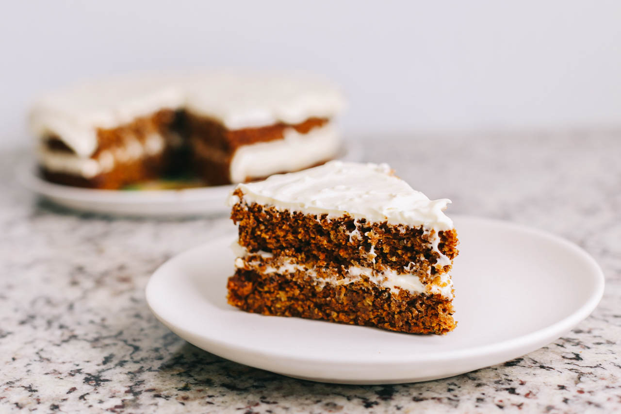 a slice of vegan carrot cake on a white plate