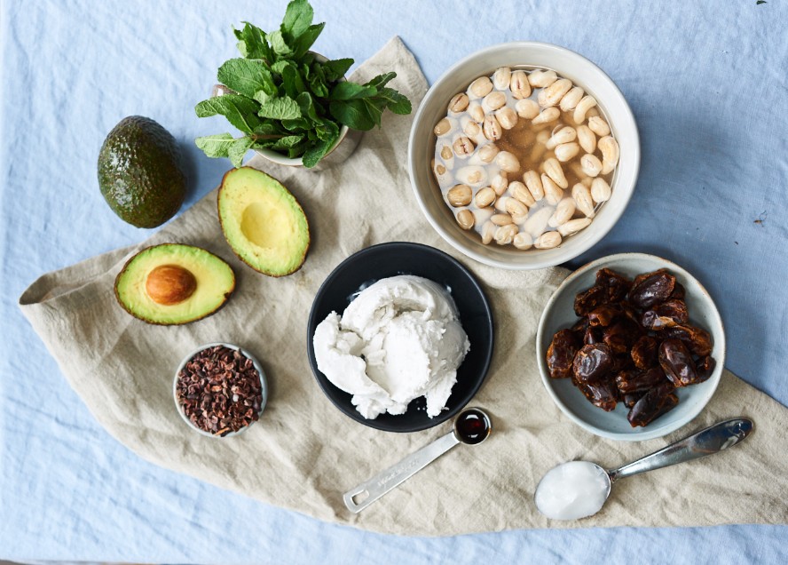 Mise en place for vegan ice cream including avocado, dates, cashews, fresh mint, cacao nibs