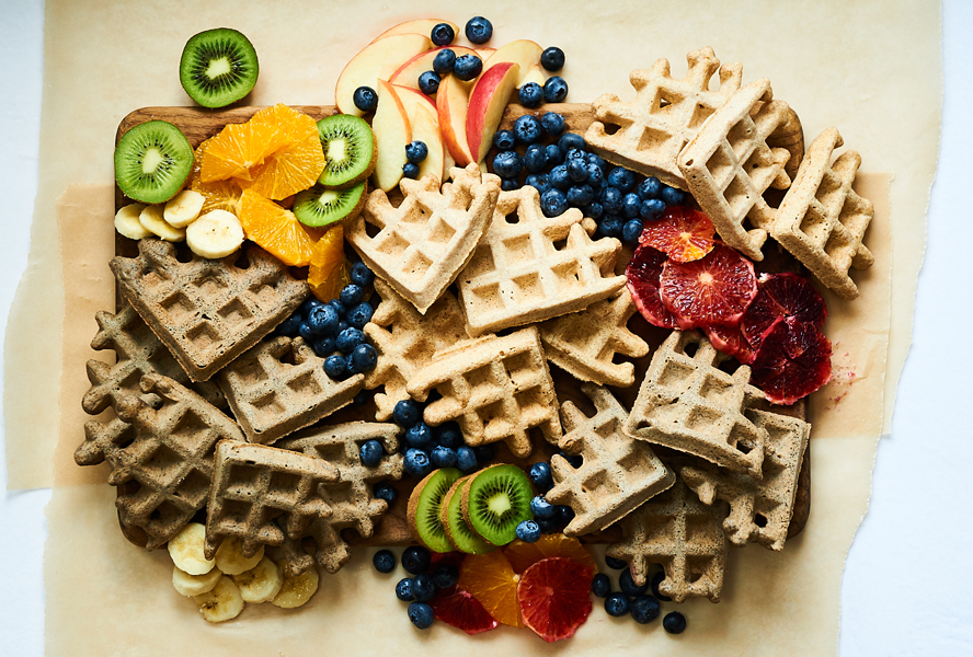 waffles and fruit on a countertop