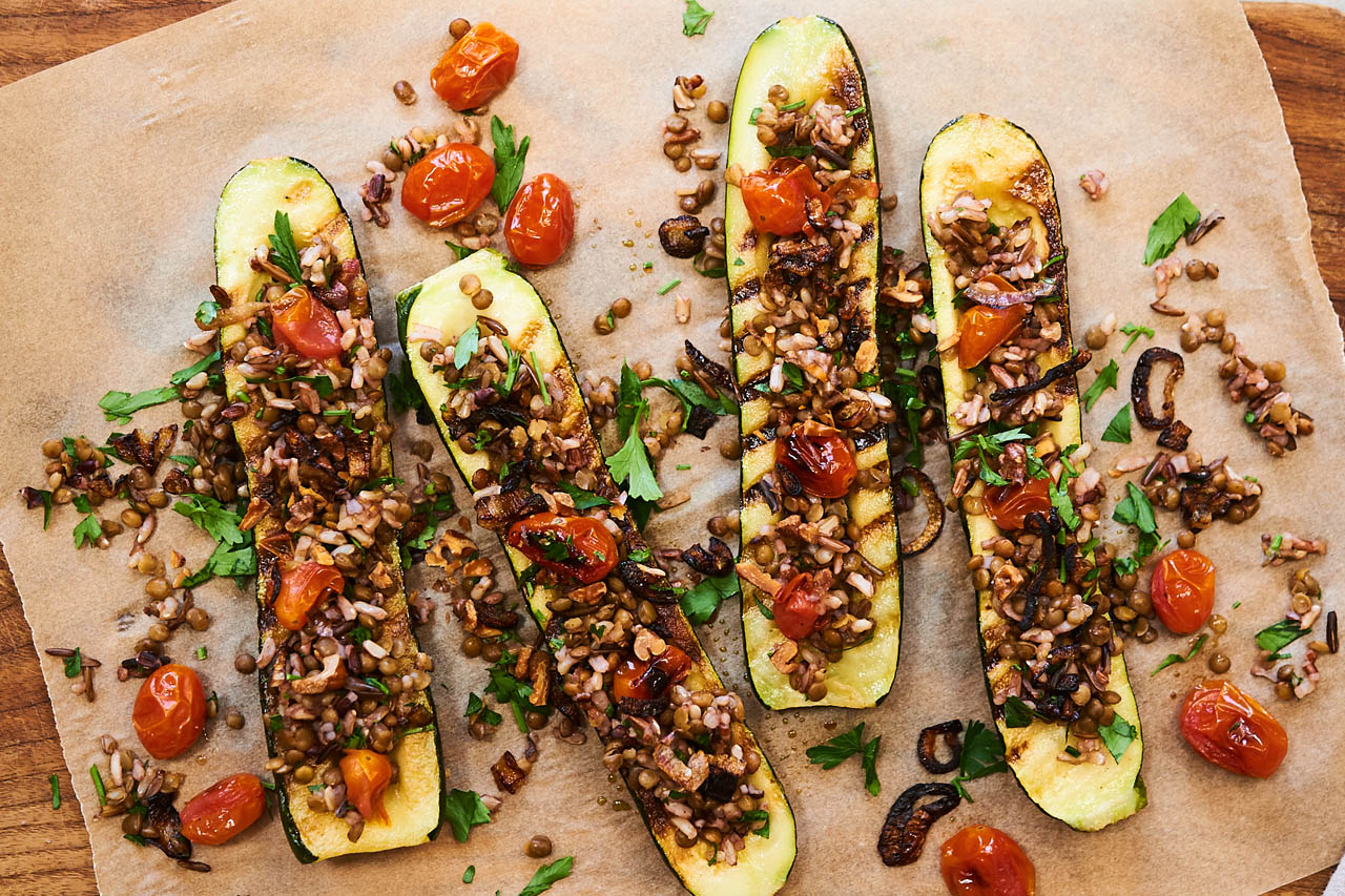 zucchini boats on a sheet of parchment paper