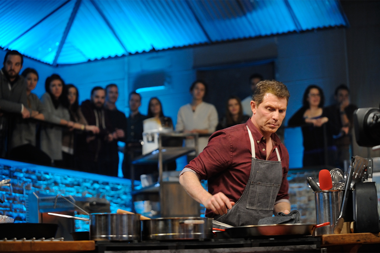 Host Chef Bobby Flay is laser-focused during the round two cookoff as the audience looks on in awe on Food Network's Beat Bobby Flay, Season 4.