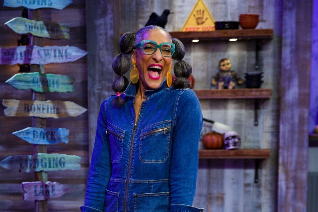 Carla Hall is laughing and has a big smile on the set of Halloween Baking Championship
