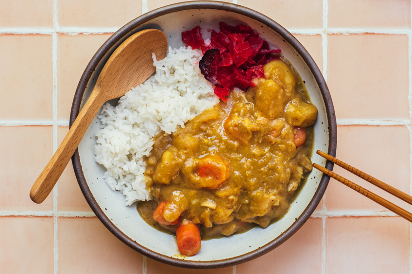 Japanese chicken curry with fresh apples plated in a bowl with rice