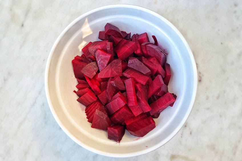 boiled, sliced beets in a white bowl
