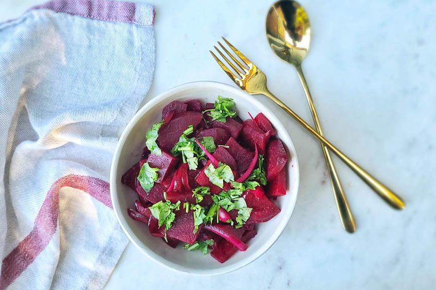 moroccan beet salad in a white bowl, ready to serve