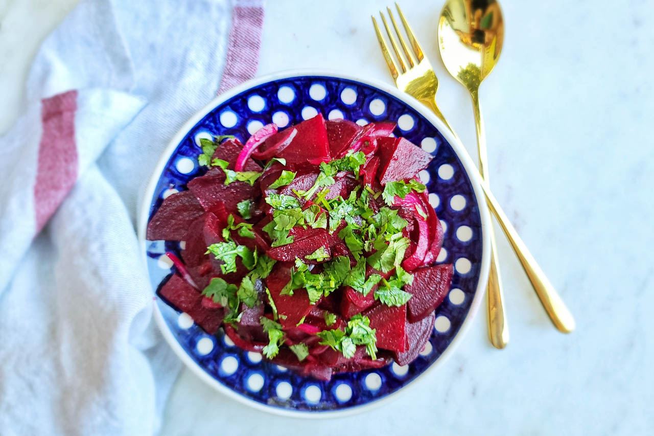 moroccan beet salad in a blue and white patterned bowl