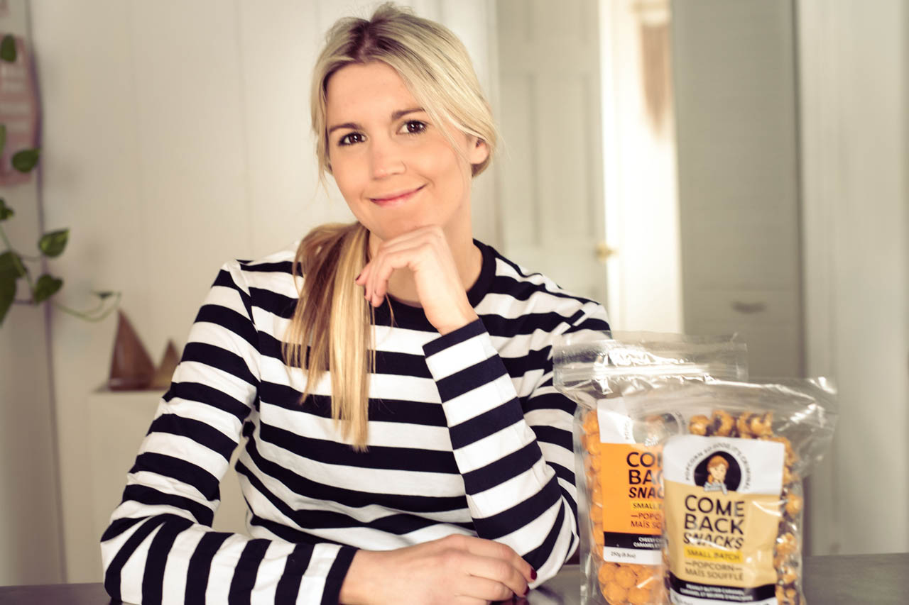 comeback snacks founder emily o'brien beside bags of her popcorn