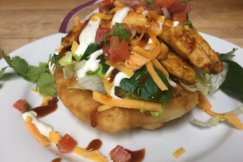 Indigenous frybread tacos on white plate