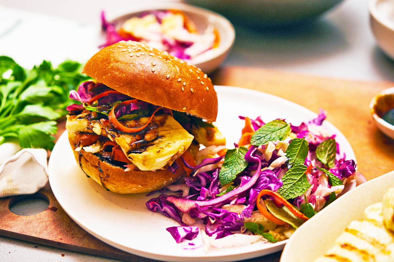 halloumi burgers with a side of rainbow coleslaw on a countertop