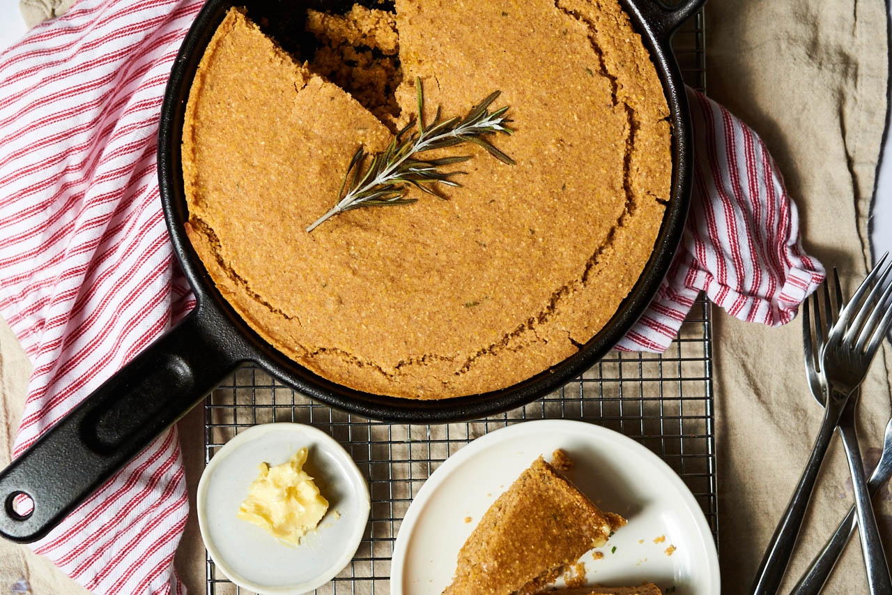 vegan cornbread with rosemary and maple on a countertop