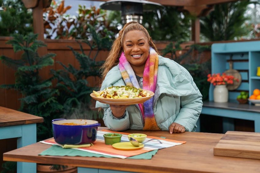 Sunny Anderson holds up her chili cheese fries