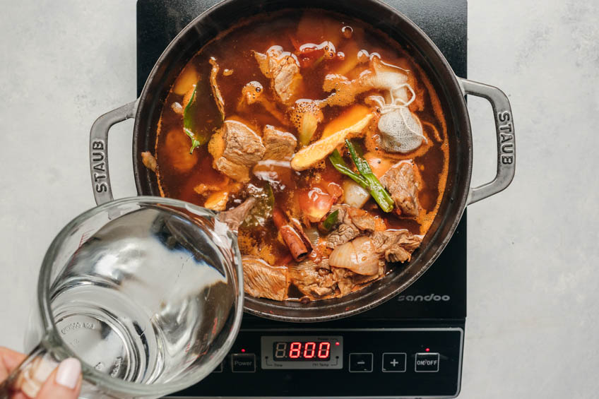 taiwanese beef noodle soup simmering in a pot