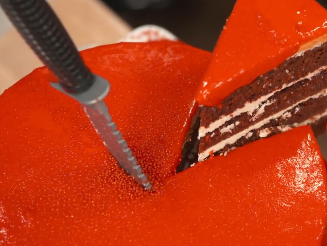 Carla Hall is taking out a slice of her tsunami cake