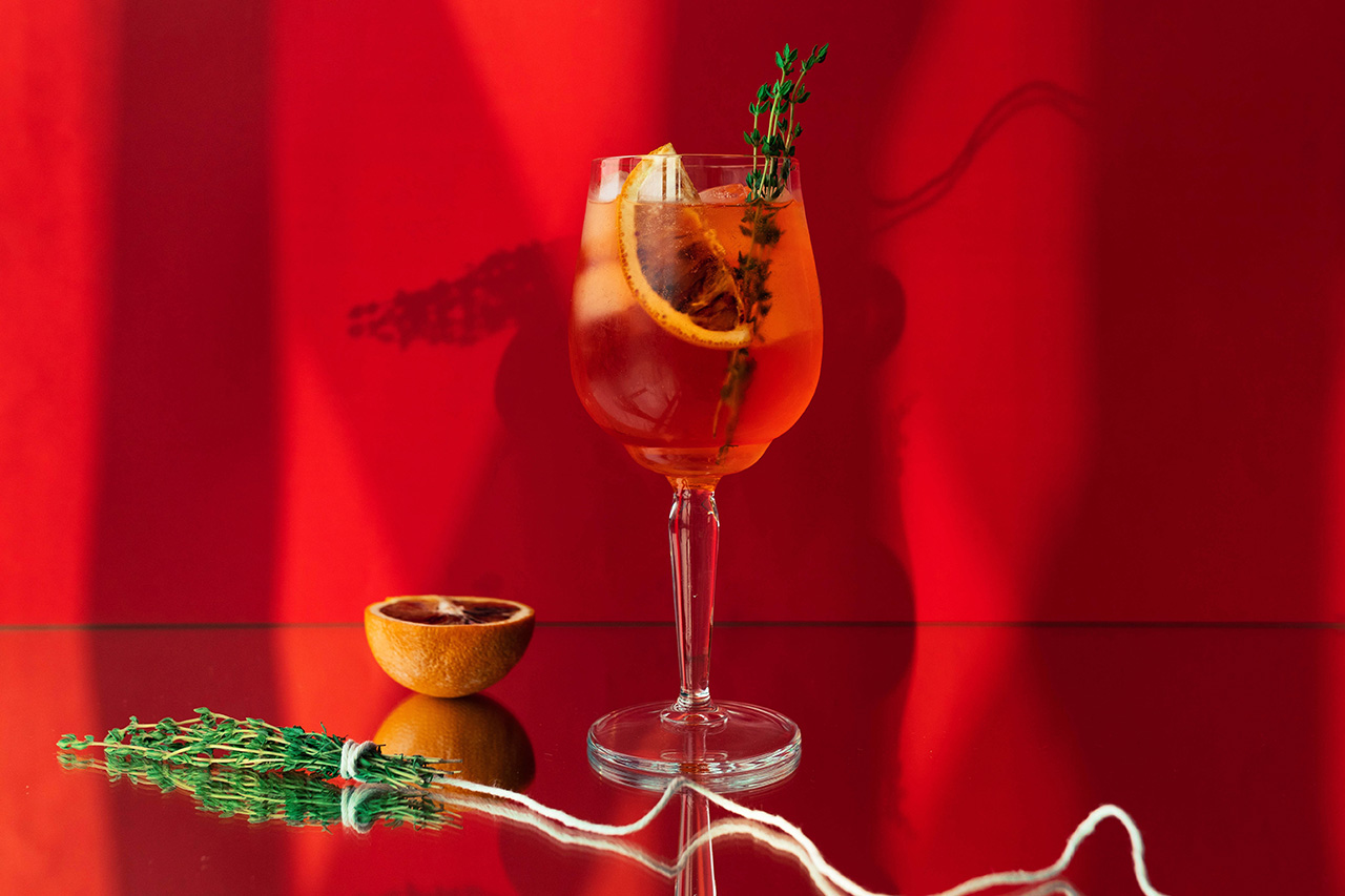 thyme aperol spritz on a counter ready to be served