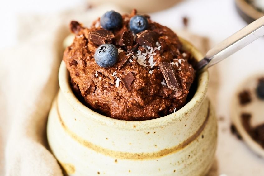vegan mug cake with chocolate and blueberries on top