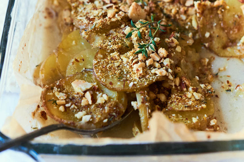 a closeup of vegan scalloped potatoes with almond crumble