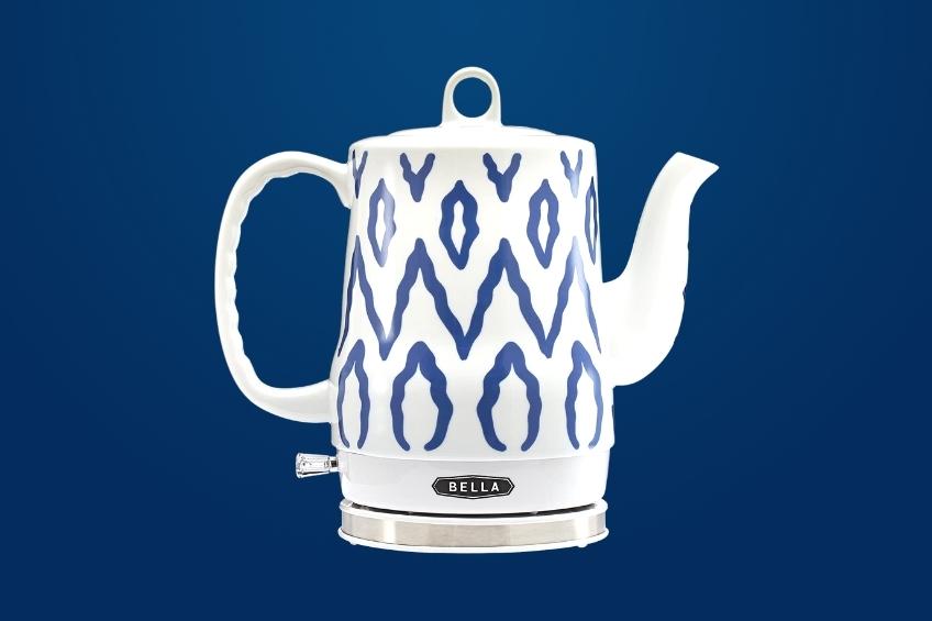A blue and white patterned electric tea kettle on a blue background.