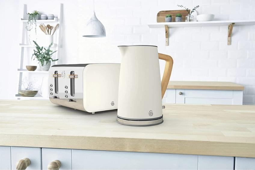 A white stainless steal kettle on a kitchen counter.