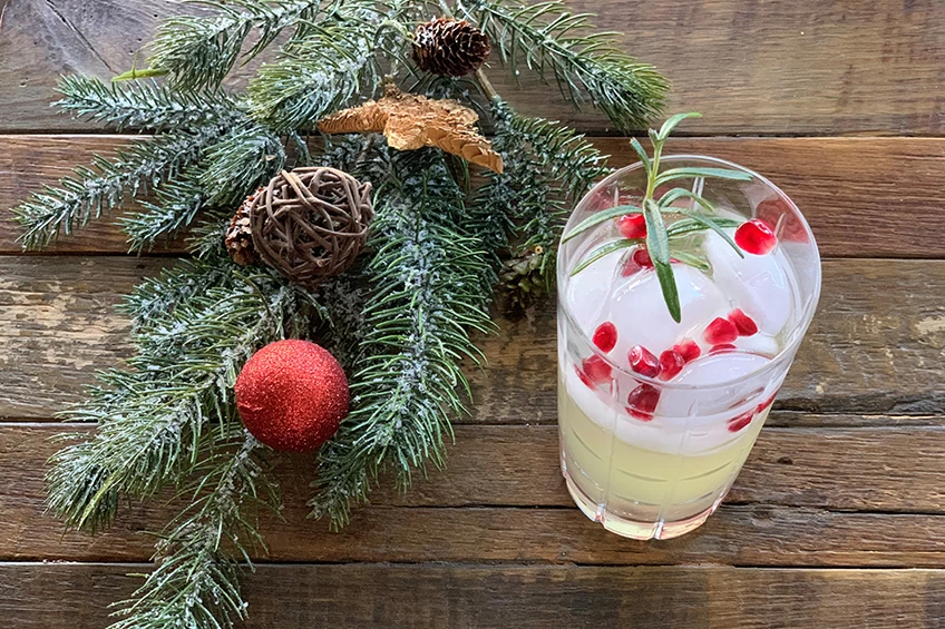 Non-alcoholic ginger-rosemary Christmas cocktail with pomegranate arils