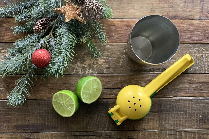 Non-alcoholic ginger-rosemary Christmas cocktail featuring lime, lemon squeezer and a tin shaker
