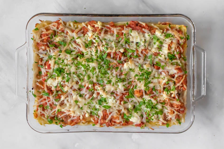 The perfect vegan lasagna topped with fresh parsley, ready to serve.