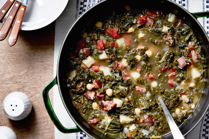A pot of Portuguese chourico and kale soup with potatoes, chickpeas and diced tomatoes