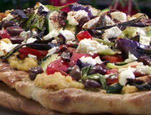 Grilled Pizza with Spicy Hummus, Vegetables, Goat Cheese and Black Olives