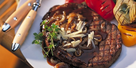 Grilled Rib Eye Steak with Canadian Cheddar and Roasted Onion Sauce